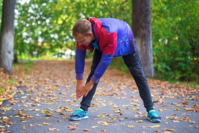 Man doing leg and back stretch