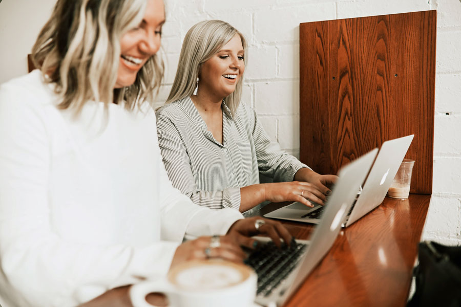 two happy women smiling at work