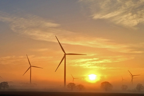 Wind turbines at sunrise producing renewable energy
