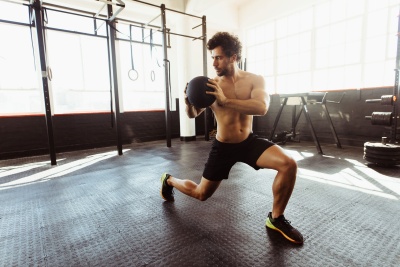 Man doing medicine ball rotations