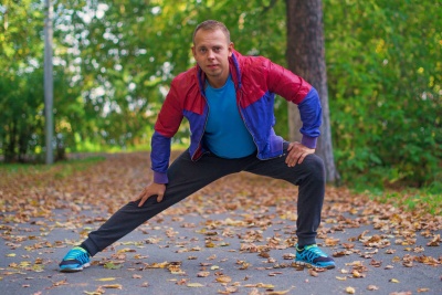 Man doing inner thigh stretches