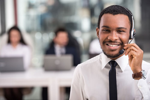Smiling man working at call centre