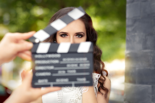 Blurred clapperboard and woman during filming
