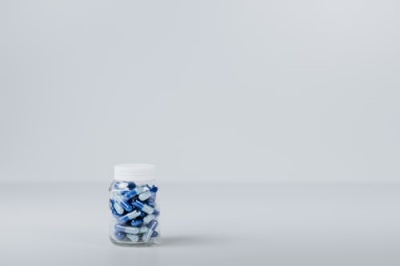 A bottle of pills on a white background