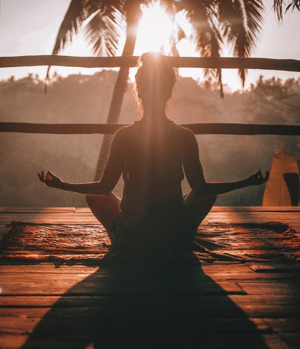someone meditating on a sand dune