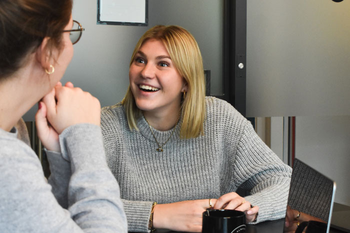 two women talking at work