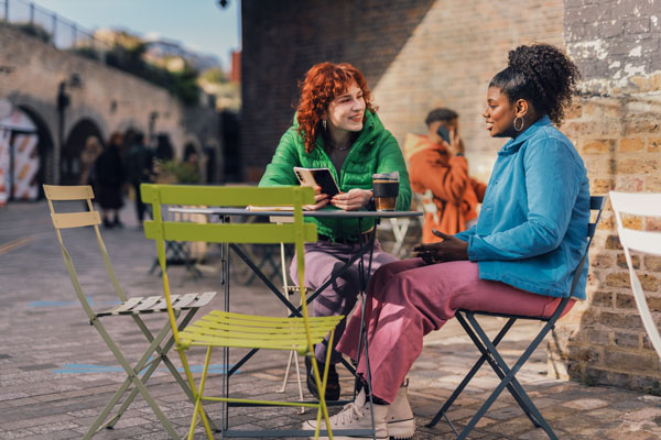 two women talking at a cafe