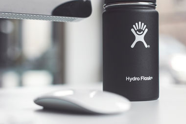 Multi-use water bottle on a desk at work