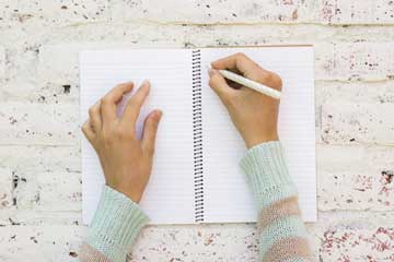 Woman writing in a journal
